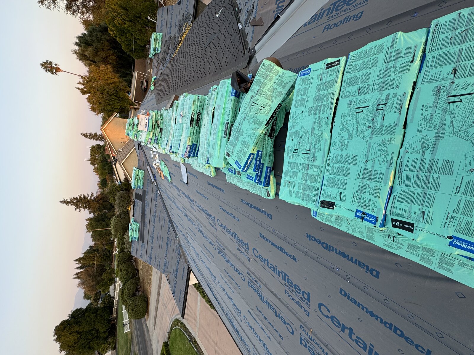 Roof replacement at sunset