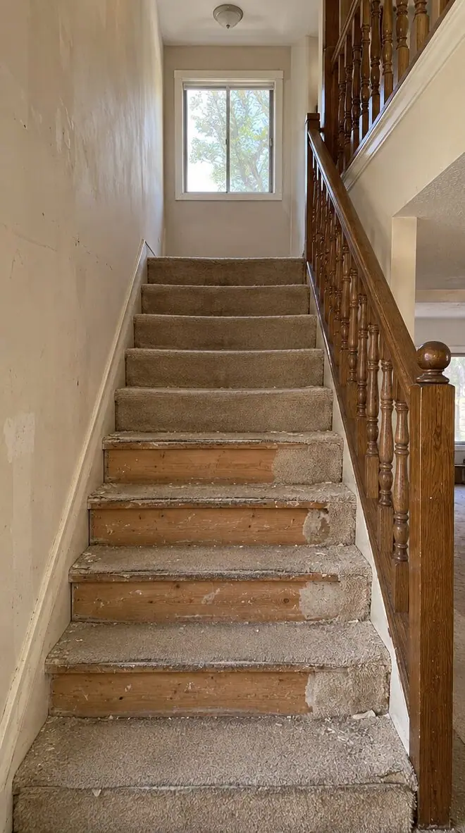 Before: worn carpeted stair hall