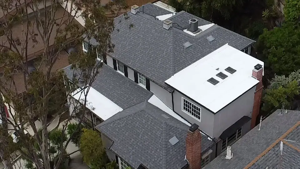 Aerial view of a combined shingle and flat roof